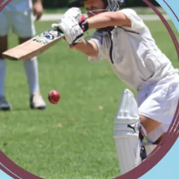 A pupil in cricket pads playing a shot on the ground