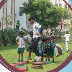 Young pupils crossing a tyre balance course with a coach