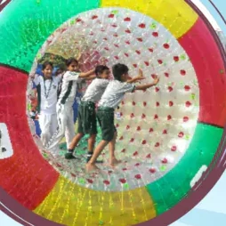 Pupils inside a large inflatable play wheel